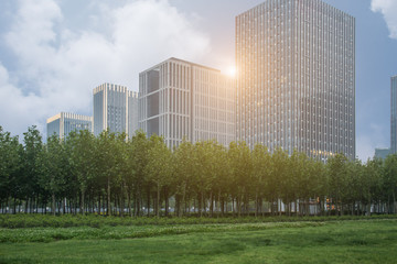 modern skyscrapers with green trees against blue sky ,shanghai,china.