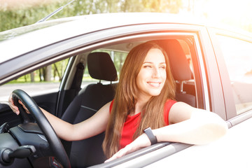 Business woman in red dress sitting in car