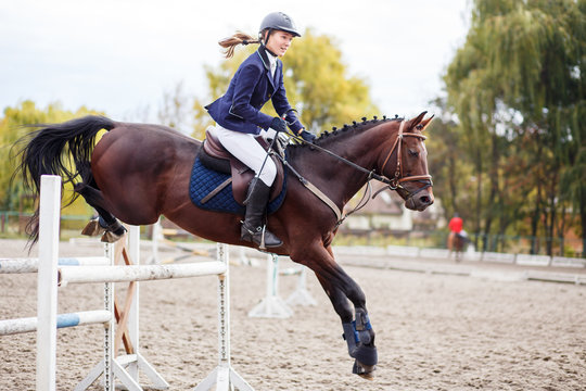 Young horse rider girl on equestrian competition