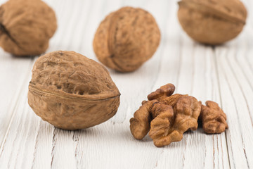 Walnut closeup on an old white table.