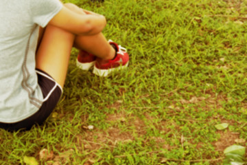 woman sitting in the park. vintage tone blur background.