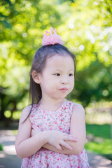 Little asian cute girl standing in park