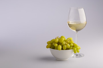 Elegant glass of white wine with grapes