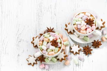 cocoa with colorful marshmallows in cups and Christmas cookies 