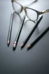 Fototapeta premium group of pencils on blackboard focus at pencil eraser, Concept s
