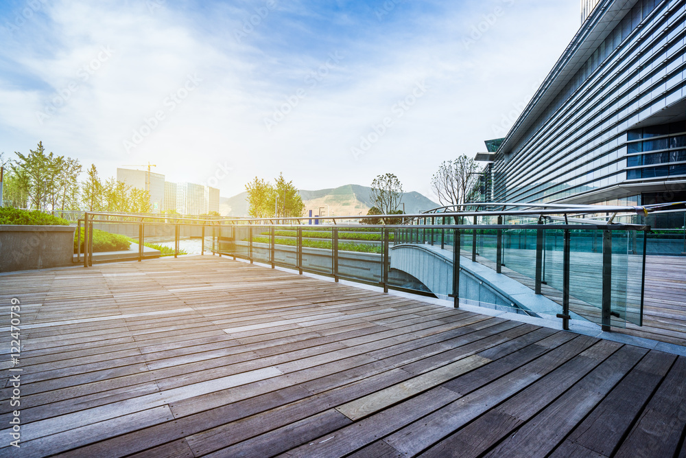 Wall mural empty wooden floor with modern buildings background,shanghai,china.