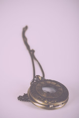 Pocket watch against a light background Vintage Retro Filter.