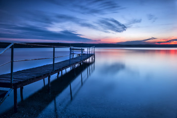 Fototapeta na wymiar Blue hour. Stunning long exposure sunset on the lake.