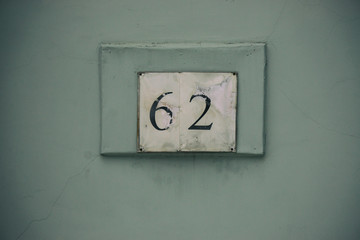 house number 62, the house number on a green background