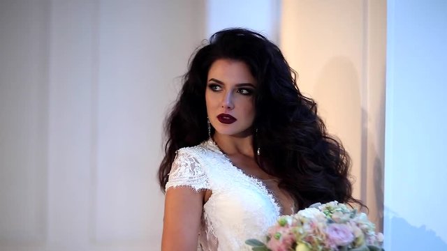 Beautiful young bride posing in studio slow motion 
