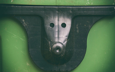 plastic door handle resembling an animal, green background