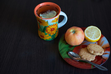apple, lemon and a cup of tea