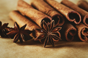 cinnamon sticks and three stars anise on brown paper background