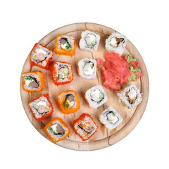 Sushi set on round wooden plate isolated on white background - Japanese cuisine