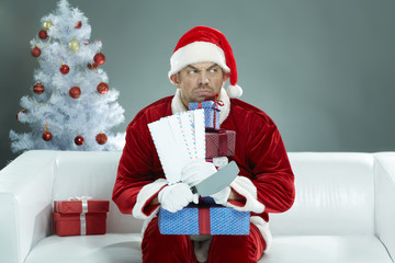 Greedy Santa griping Christmas presents and letters and snapping