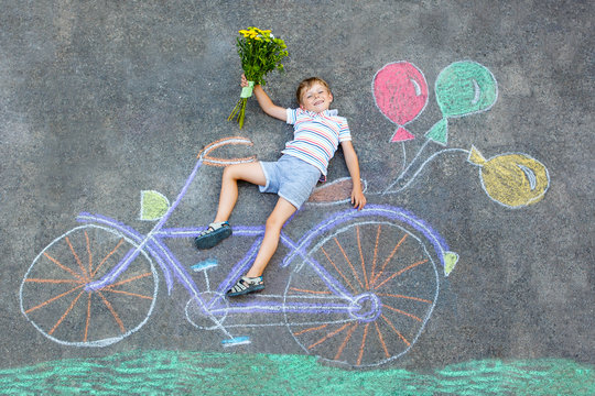 little kid boy having fun with bike chalks picture 