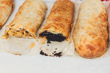 Sweet strudel with poppy and apples choice on trays
