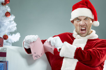 Evil Santa tearing letters to real Santa 