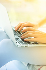 Fototapeta na wymiar Closeup of woman hand working with typing on laptop keyboard