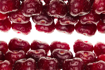  Heap of ripe cherries with water drops on a white background. Decorative frame of fruits. Isolated. Macro. Food background. Copy space.
