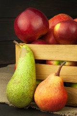 Pears and apples on wooden table. Autumn Fruits. Autumn harvest on the farm. A healthy diet for children.

