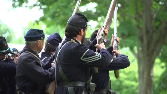 Civil War soldiers fire bullets at confederates