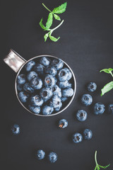 Blueberry on black background. Top view, flat lay