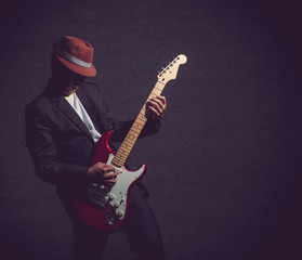 Musician playing the guitar on dark background,music concept