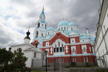 Fototapeta na wymiar Valaam Orthodox Christian men Monastery under dark cloudy sky on Ladoga in northern Russia