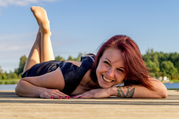 Fashion portrait of young sensual woman near river