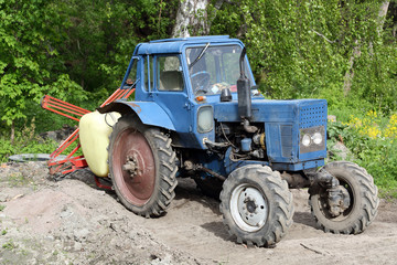 Old blue tractor on natural background outdoor
