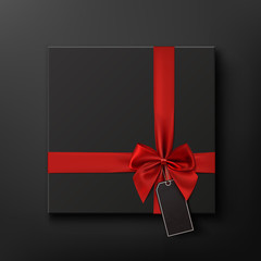 Blank, black gift box with red ribbon and price tag.