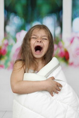 Cute little girl wrapped in blanket yawns - morning awakening © jelenaaloskina