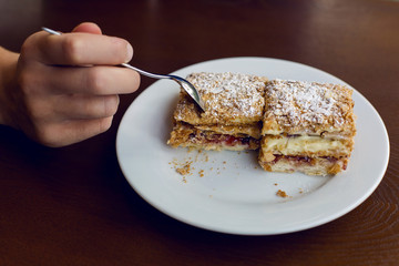 two dessert standing the hand with the spoon