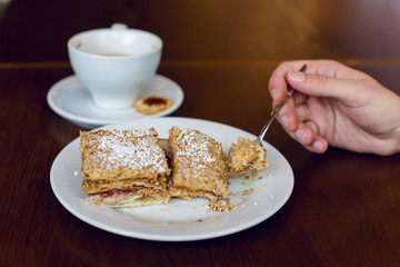 two dessert standing the hand with the spoon