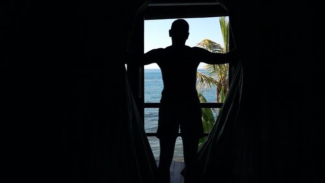 Silhouette of man unveil curtains in room, super slow motion 240fps
