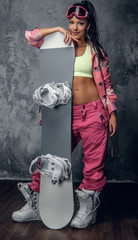 Full body studio portrait of female in a ski clothes.