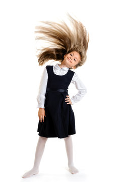 Portrait of joyful schoolgirl with flying hair on white background