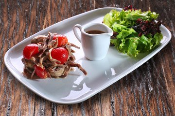 Salad with meat, tomatoes and lettuce.