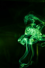 Green smoke movement on black background.