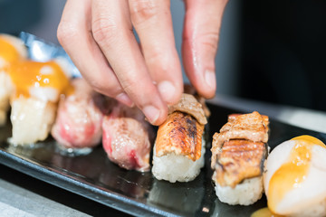 Close up hand of Japanese chef making sushi

