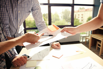 Male manager putting his ideas and writing business plan at workplace,man holding pens and papers,...
