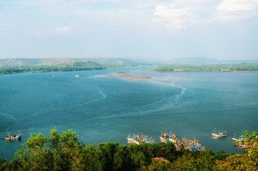 Chapora river with fish market and fishing boats. View of Chapora and Morjim coastline from Chapora Fort, North Goa, India