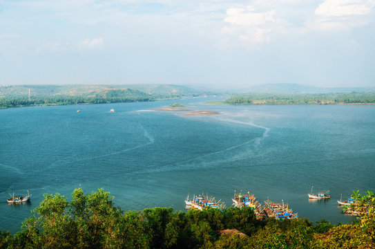 Chapora river with fish market and fishing boats. View of Chapora and Morjim coastline from Chapora Fort, North Goa, India