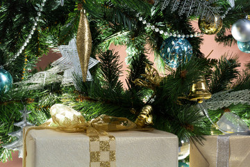Fototapeta na wymiar Beautiful gift lies near the Christmas tree