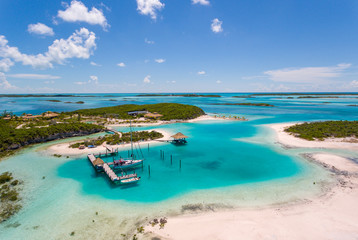 Aerial view of exotic island with authentic buildings and pier for yachts