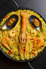 Spanish paella on black background