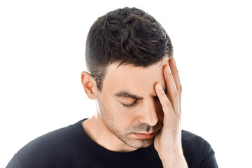Fototapeta premium Portrait of stressed man having headache isolated on white backg