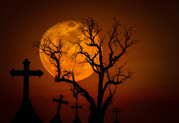 halloween dark grunge concept background with spooky crosses in mystic graveyard and scary dead tree with full moon.