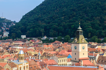 Fototapeta na wymiar Clock tower and roof tiles in Brasov, Transylvania, Romania 